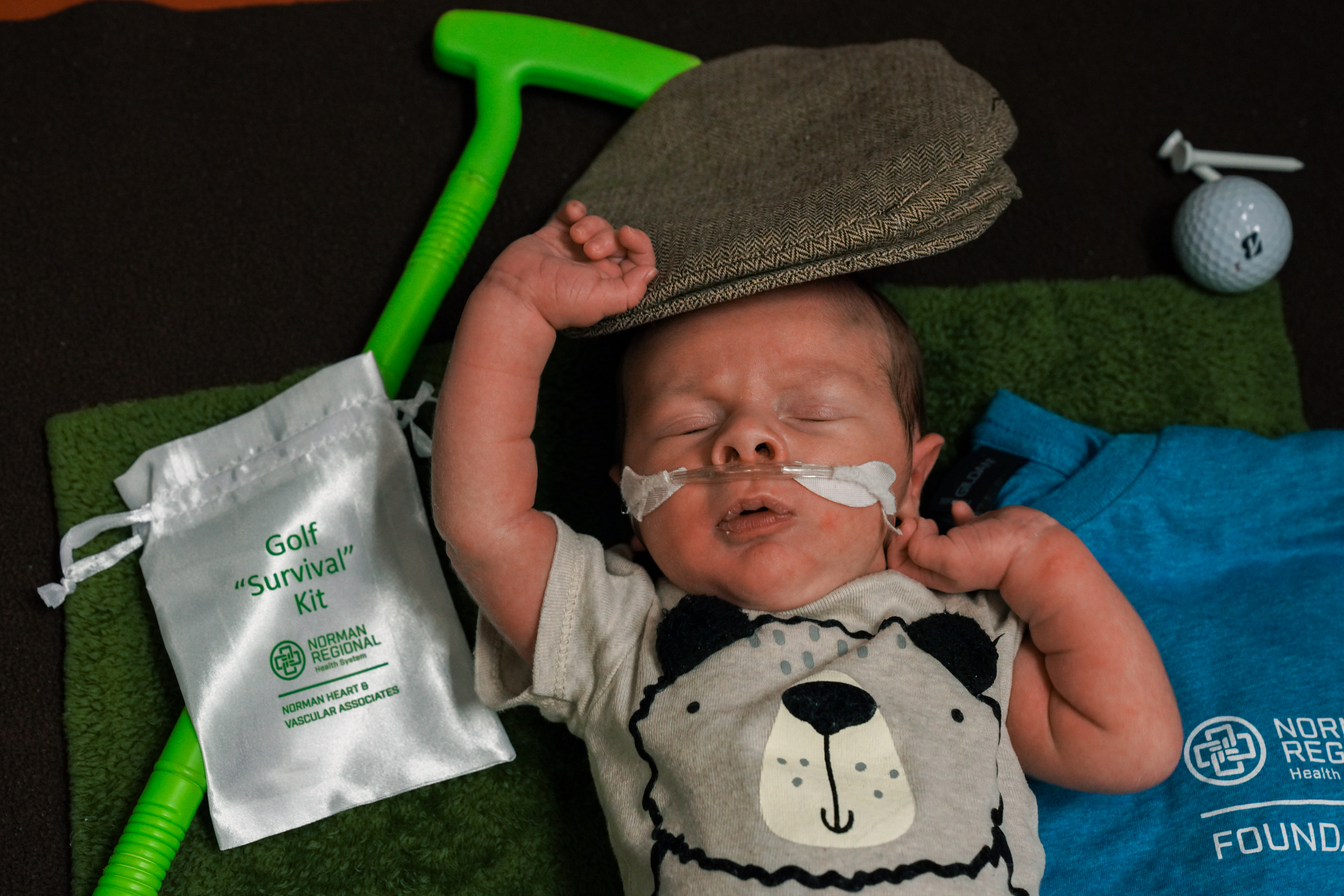 NICU baby next to gold survival kit