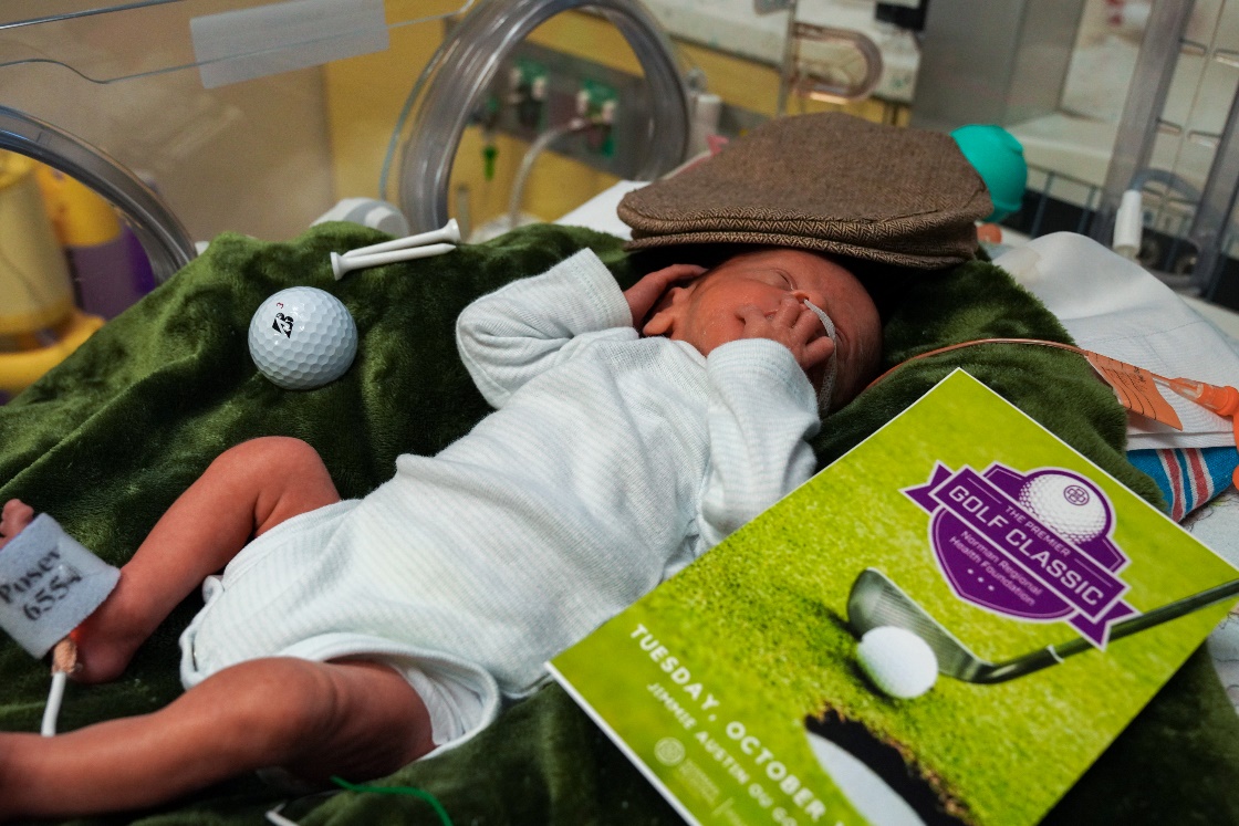 NICU baby next to golf ball