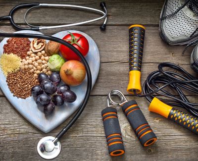 healthy food next to a jump rope and stethoscope